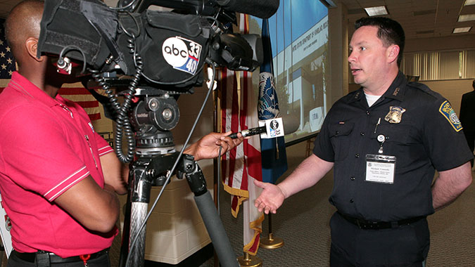 Michael Connolly, Boston Police Officer, answers questions from local media following his comments at the CDP's 15th Anniversary celebration in June. Connolly credits CDP training for his unit's response following the Boston Marathon bombing.