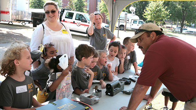 Matt Lowery, CDP instructor, explains the equipment used by emergency responders to clean or decontaminate survivors following a hazardous incident. Several emergency response organizations provided large displays during Ready Alabama Day held at Auburn University.