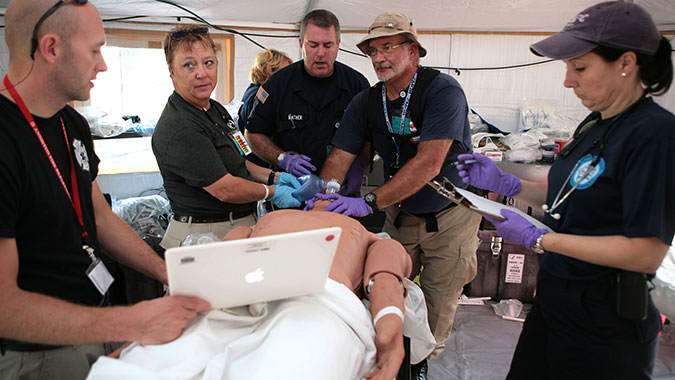 DMAT members treat the symptoms shown by a patient simulator while training at FEMA’s Center for Domestic Preparedness (CDP). A DMAT is a group of professional medical personnel, supported by logistics and administrative teams. The teams are designed to provide medical care during a disaster or othe