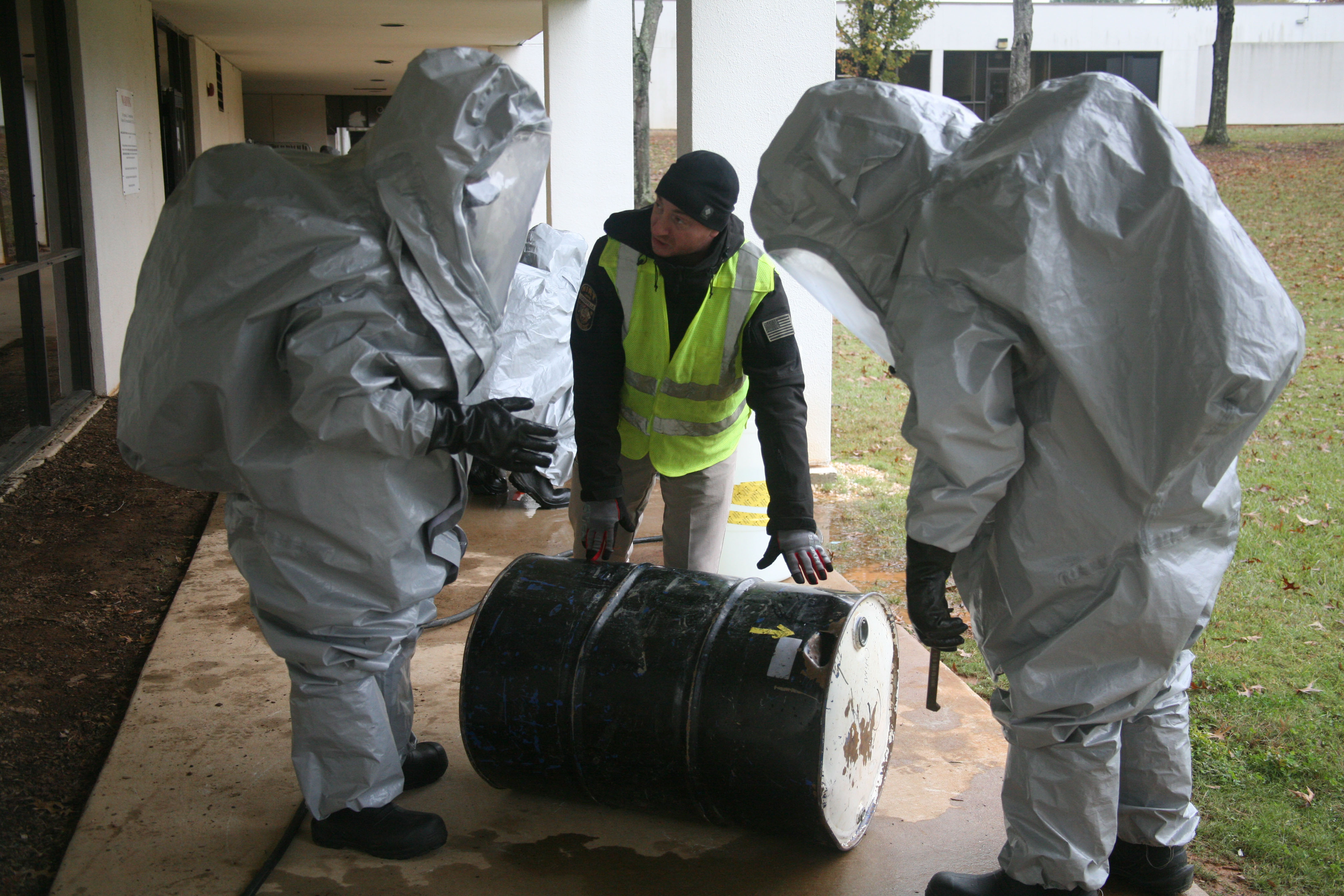 CDP Instructor Jeremy Urekew, center, points out damages on a training barrel to students attending the Hazardous Materials Technician course, noting that punctures in barrels can lead to emissions of both liquid and gaseous hazardous material.