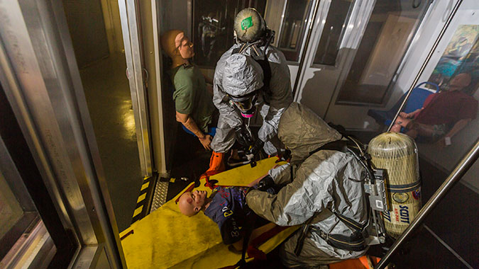 Students prepare a “patient” for transport from the subway training venue in the CDP’s Advance Responder Training Complex.