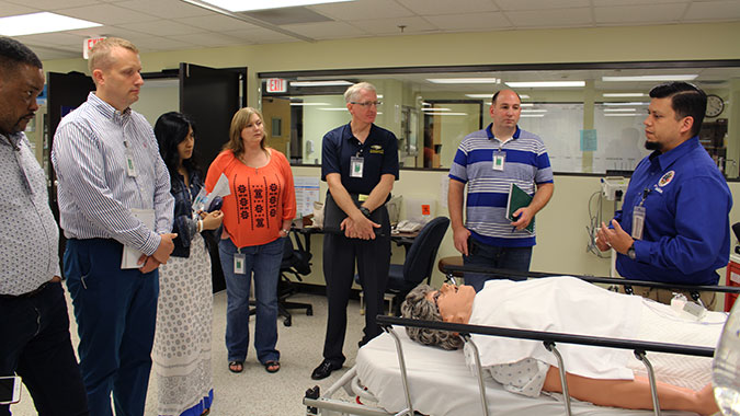 Ian Jones, Medical Simulation Technician Team Lead, at the CDP’s Noble Training Facility, demonstrates the abilities of a human patient simulators for the students.