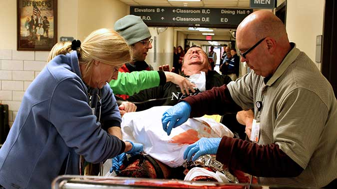 JoAnne Ray, an emergency department charge nurse from Guntersville, Ala., and John Coffey, a safety specialist and emergency and disaster preparedness coordinator with Saint Vincent’s Medical Center in Jacksonville, Fla., treat a seriously injured “patient” in the Noble Training Facility Emergency D