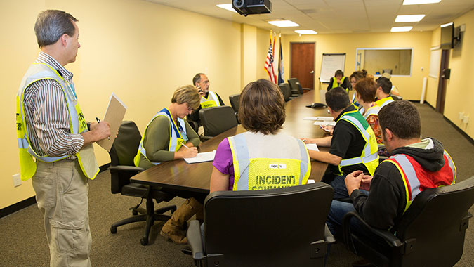 Kansas hospital lead staff discuss response procedures in the hospital’s command center conference room.