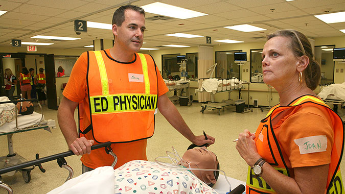 Michigan healthcare employees treat the symptoms of a Human Patient Simulator following a scenario-based mass-casualty incident at the Center for Domestic Preparedness. Nearly 140 healthcare personnel, representing more than 25 Michigan hospitals, attended training.