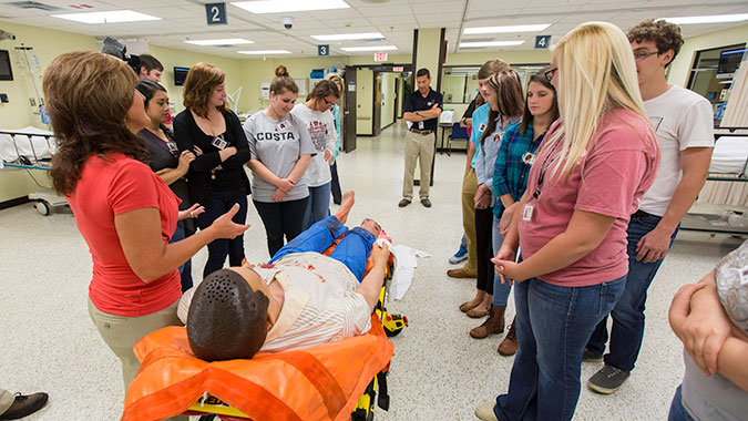 Students learn how a patient simulator is used in healthcare training during a tour of the Center for Domestic Preparedness (CDP). Fifty local high school students, enrolled in Community Emergency Response Team Training, toured the CDP on FEMA’s first National Day of Action.