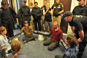 Helena law enforcement discuss the procedures they must take to remove protesters from the state capitol in July 2011