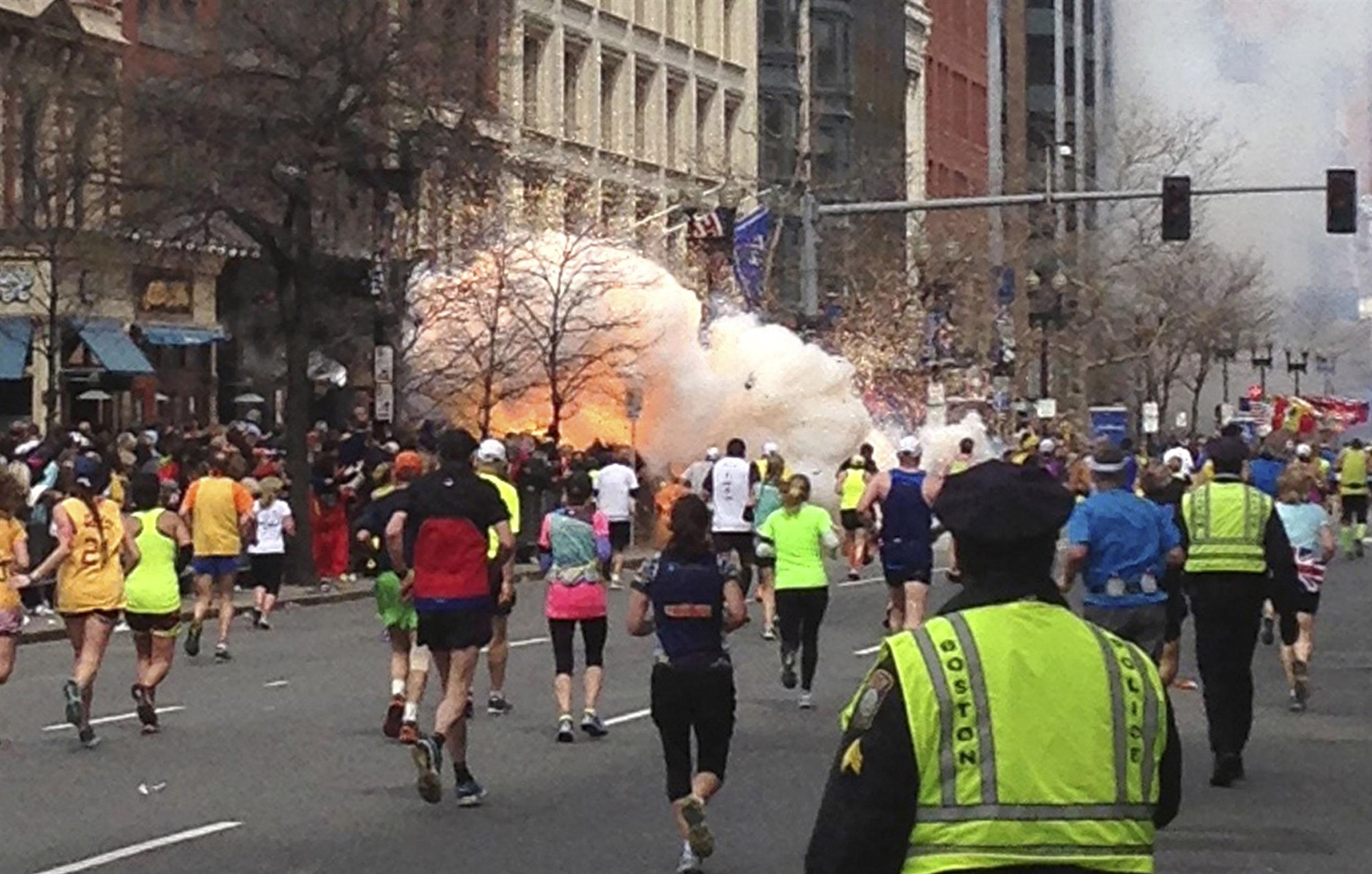 Runners continue to run towards the finish line of the Boston Marathon as an explosion erupts near the finish line of the race in this photo exclusively licensed to Reuters by photographer Dan Lampariello after he took the photo in Boston, Massachusetts, April 15, 2013. Two simultaneous explosions ripped through the crowd at the finish line of the Boston Marathon on Monday, killing at least two people and injuring dozens on a day when tens of thousands of people pack the streets to watch the world famous race.Dan Lampariello / Reuters, file