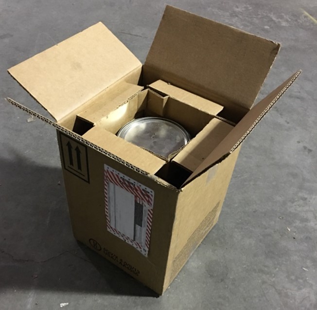 Photo of an open cardboard box with an inner container.